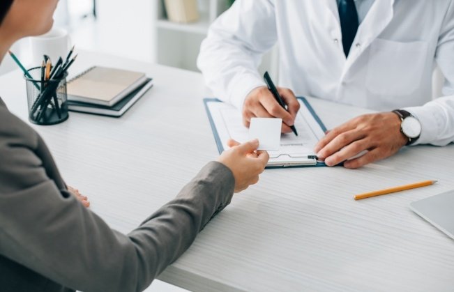 Dentist reviewing dental insurance forms