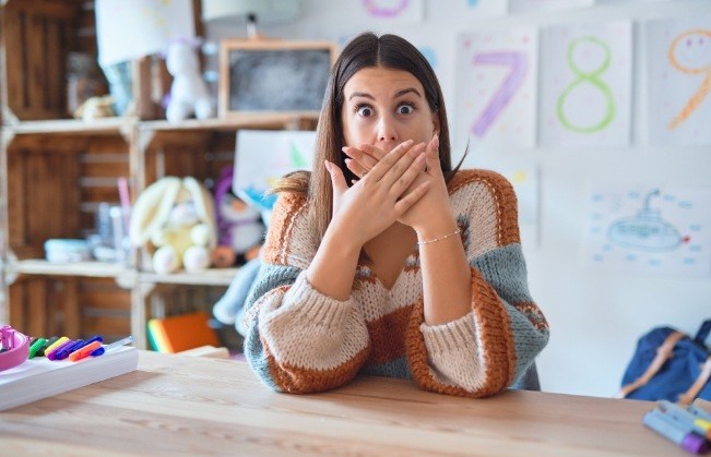 Woman covering her mouth before emergency dentistry