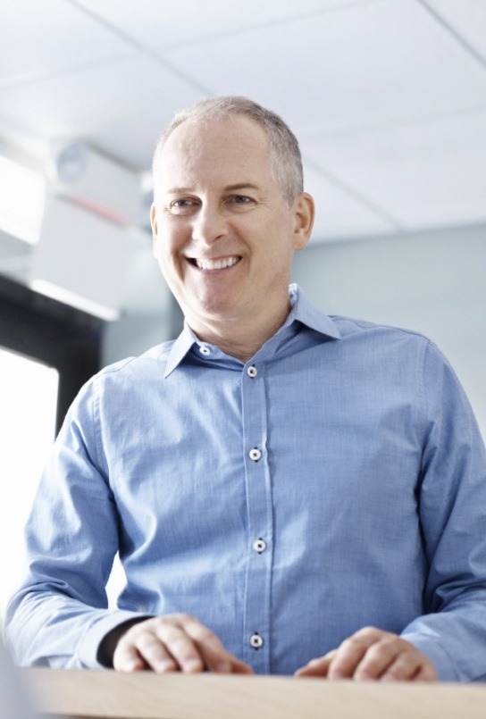 Man smiling at dental team member