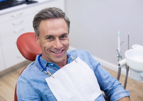 Doctor Ong talking with dental patient