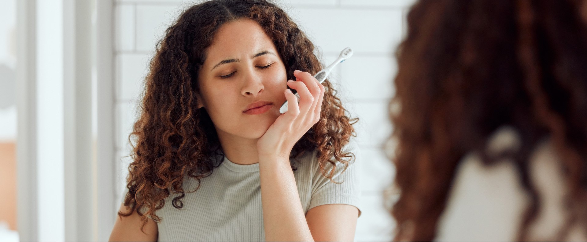 Woman in pain before visiting her emergency dentist in Renton Washington