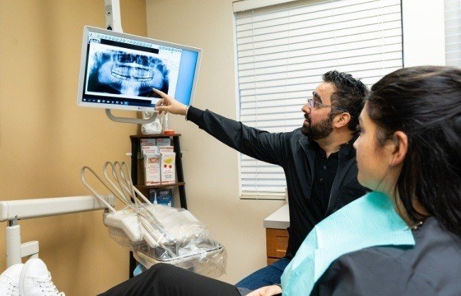 Doctor Dhaliwal and dental patient looking at digital x rays