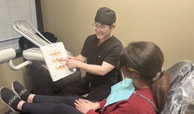 Dentist and dentistry team member treating dental patient