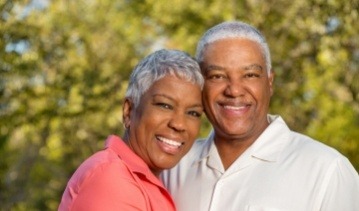 Man and woman sharing smiles after restorative dentistry