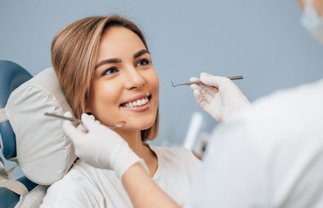 Woman receiving dental checkup and teeth cleaning