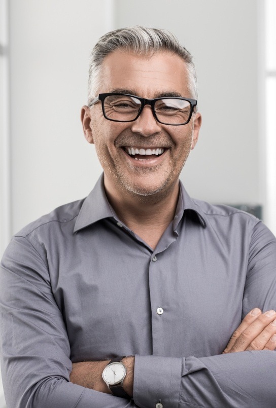 Man laughing after replacing missing teeth