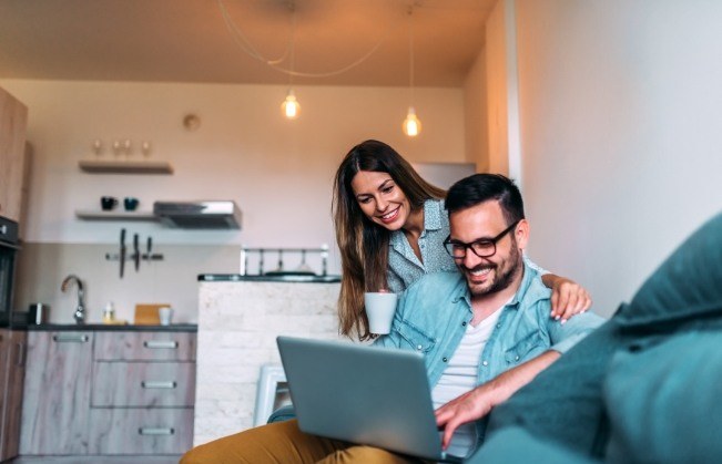 Man and woman using laptop to leave a review