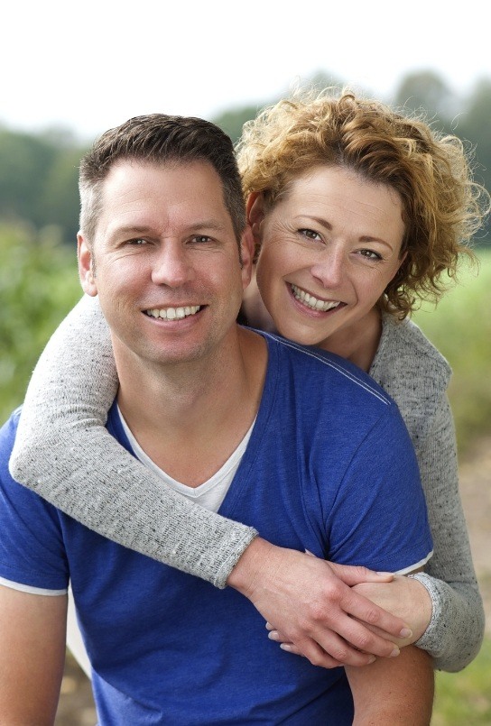 Man and woman smiling after root canal treatment