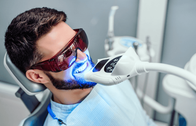 Male dental patient receiving teeth whitening in Renton, WA